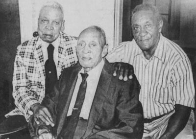 Shortly before his 104th birthday, with his two sons, Sammy (left) and Joe (right). (Source: The Enterprise-Tocsin)